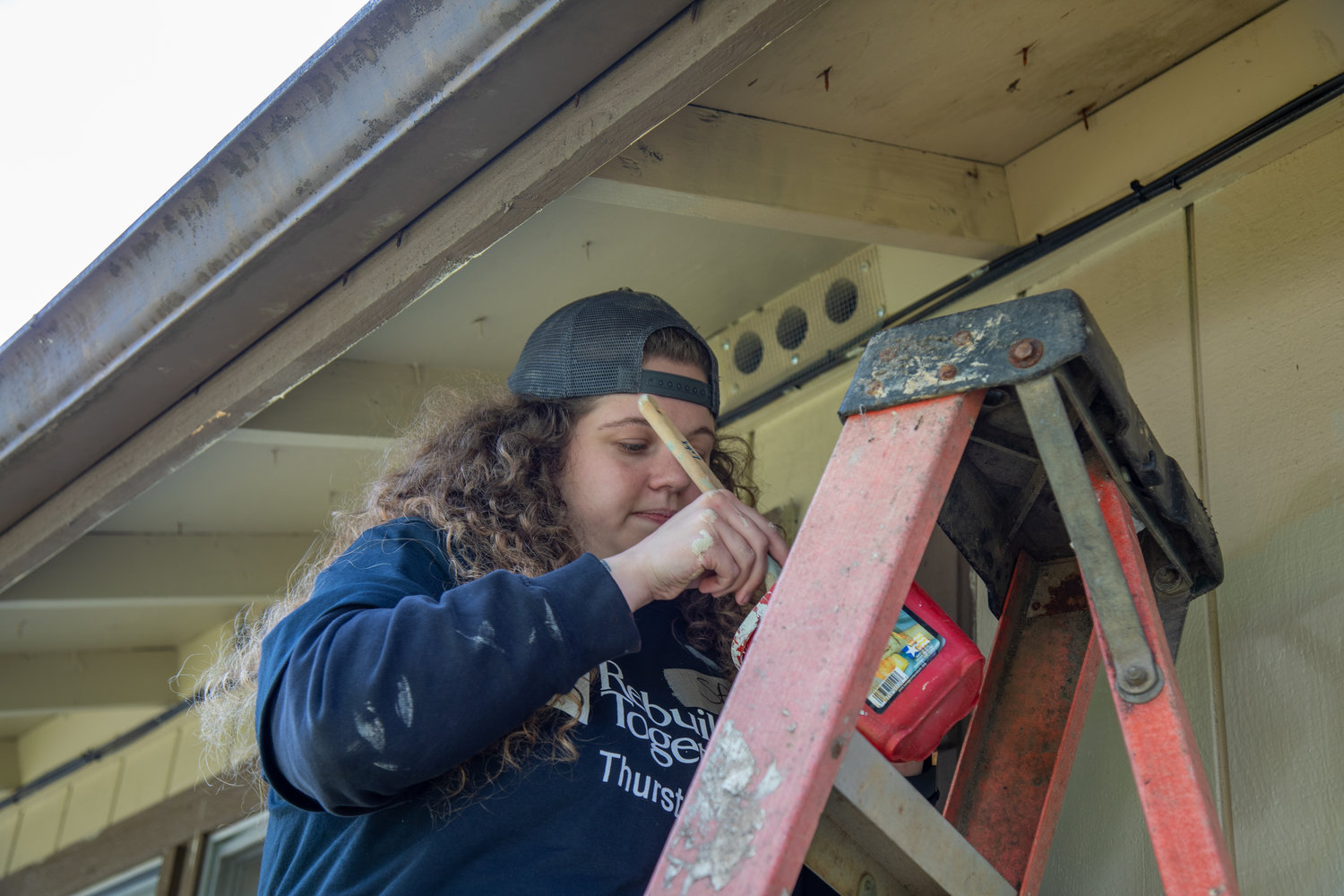 A Rebuilding Together Thurston County volunteer makes repairs on a client's home.